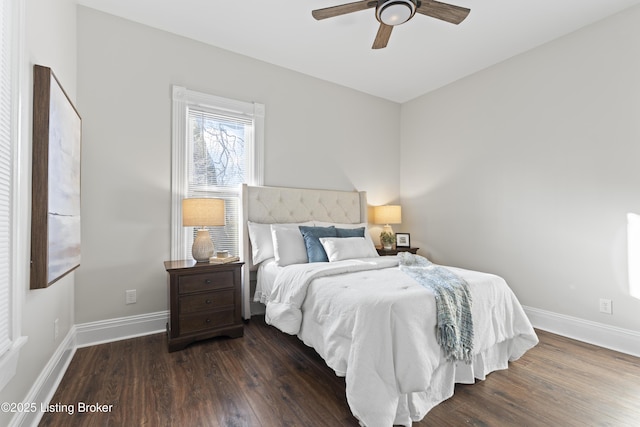 bedroom with ceiling fan, baseboards, and dark wood-type flooring