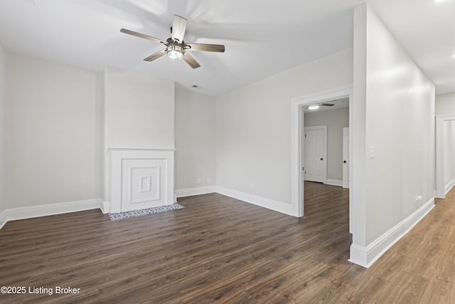 unfurnished room featuring ceiling fan, dark wood finished floors, visible vents, and baseboards