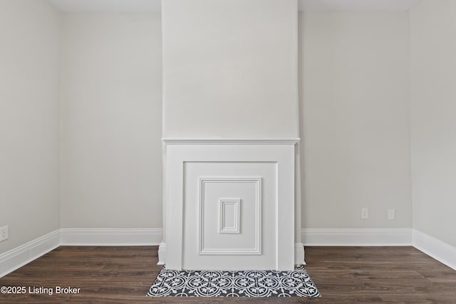 details featuring wood finished floors and baseboards