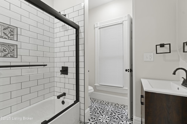 full bath with tile patterned flooring, enclosed tub / shower combo, vanity, and toilet