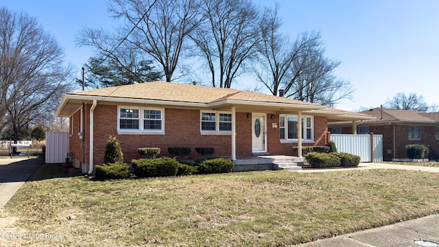 single story home with brick siding and a front lawn