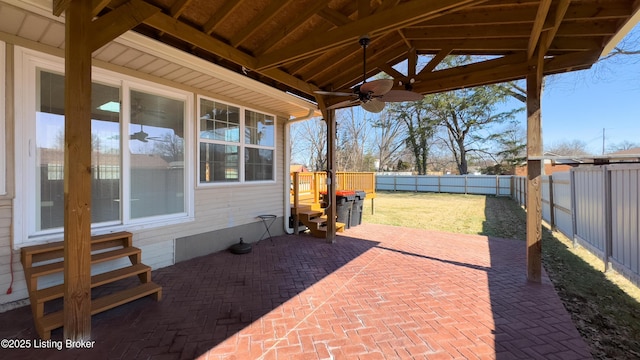 view of patio / terrace with entry steps, a fenced backyard, and a ceiling fan