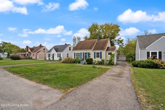 view of front of property with an outbuilding, a front yard, and a residential view