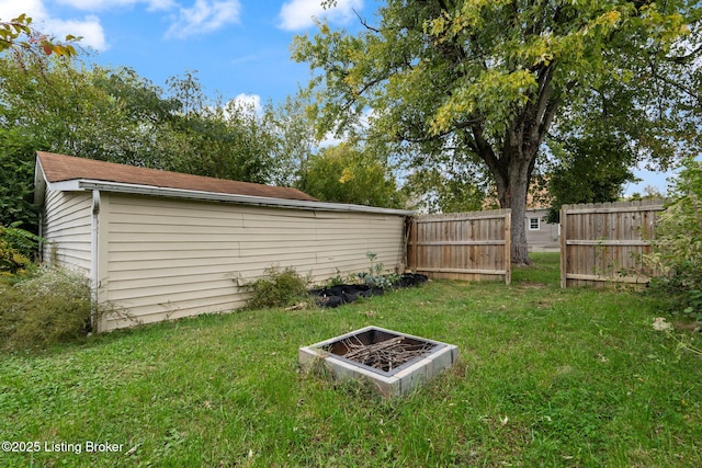 view of yard with an outdoor fire pit and fence