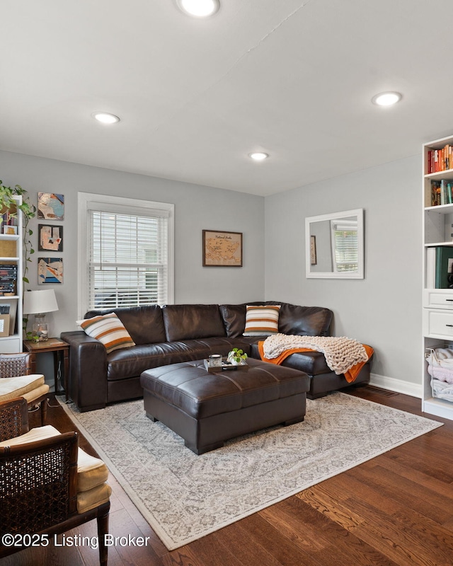 living room with baseboards, wood finished floors, and recessed lighting