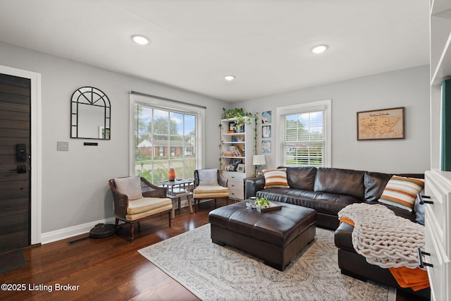 living room with dark wood-style flooring, recessed lighting, visible vents, and baseboards