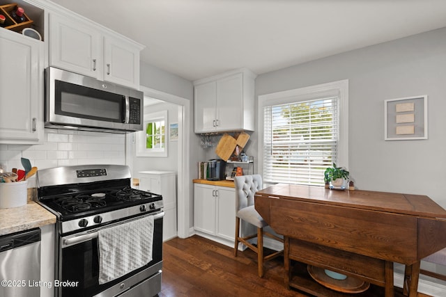 kitchen featuring light countertops, appliances with stainless steel finishes, and white cabinets