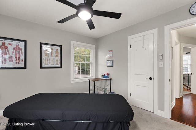 carpeted bedroom featuring ceiling fan and baseboards