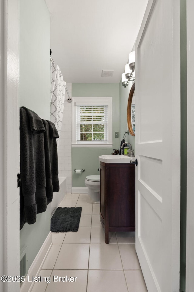 full bathroom with tile patterned flooring, toilet, visible vents, vanity, and shower / bath combo with shower curtain