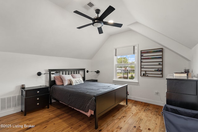 bedroom with baseboards, visible vents, lofted ceiling, ceiling fan, and light wood-style floors