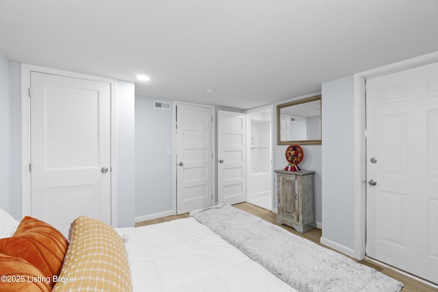 bedroom with recessed lighting, visible vents, baseboards, and wood finished floors