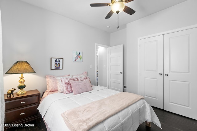 bedroom featuring dark wood-style floors, a closet, and a ceiling fan