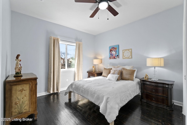 bedroom with a ceiling fan, dark wood finished floors, and baseboards