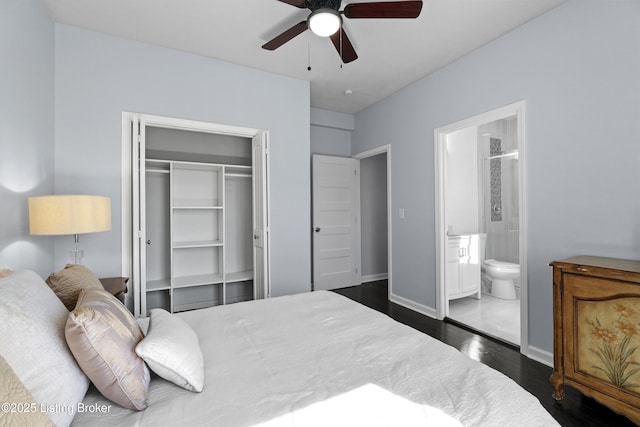 bedroom featuring ensuite bathroom, ceiling fan, wood finished floors, baseboards, and a closet