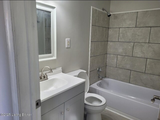 bathroom with shower / bath combination, toilet, and vanity