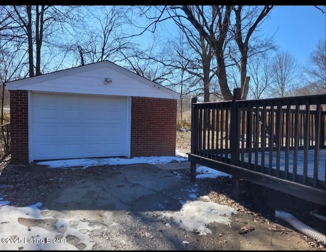 snow covered garage with a garage