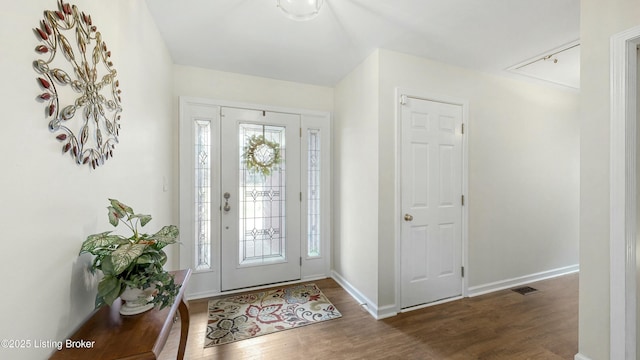 entrance foyer with visible vents, baseboards, and wood finished floors