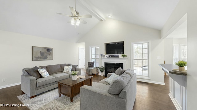 living room with dark wood-type flooring, a fireplace with flush hearth, beam ceiling, and baseboards