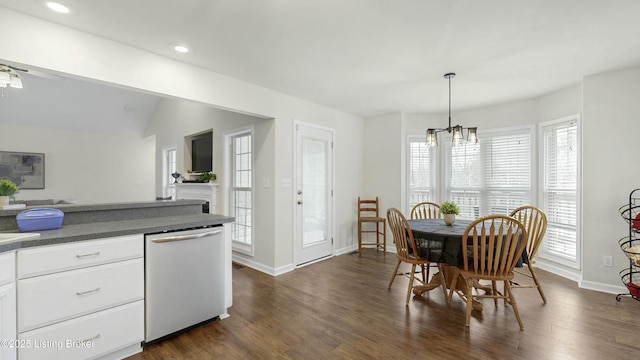 dining space with baseboards, dark wood-style flooring, an inviting chandelier, vaulted ceiling, and recessed lighting