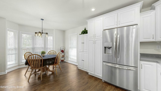 dining space with baseboards, dark wood-type flooring, an inviting chandelier, and recessed lighting