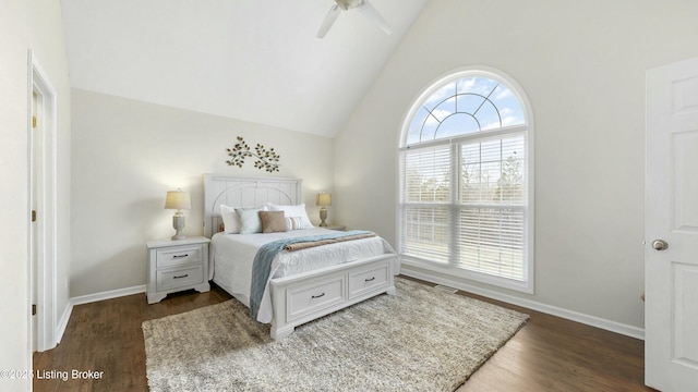 bedroom featuring dark wood-style flooring, multiple windows, vaulted ceiling, and baseboards