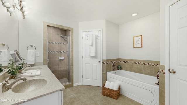 full bath featuring double vanity, a stall shower, a garden tub, and a sink