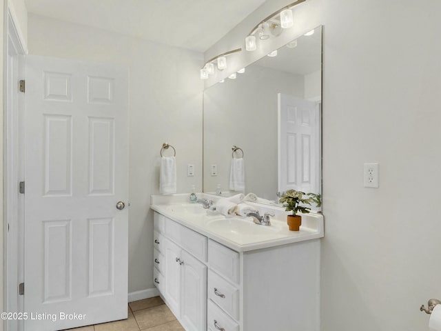 bathroom with double vanity, tile patterned flooring, and a sink