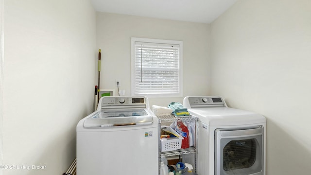 washroom featuring laundry area and separate washer and dryer