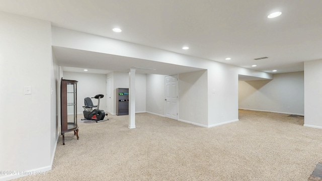 finished below grade area featuring recessed lighting, visible vents, baseboards, and light colored carpet