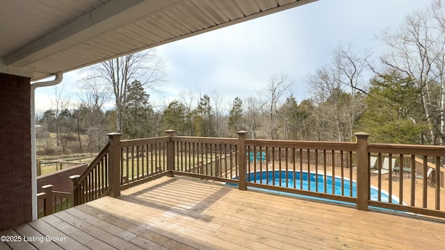 wooden terrace with a fenced in pool