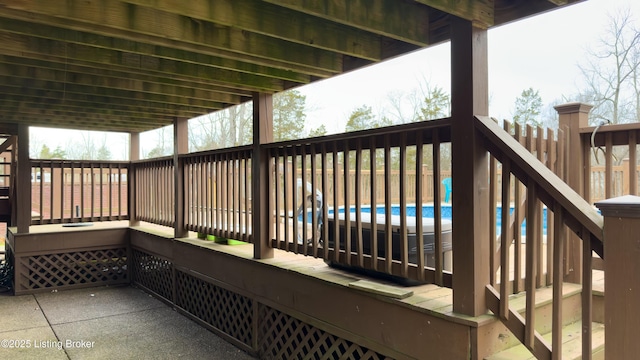 wooden terrace featuring an outdoor pool