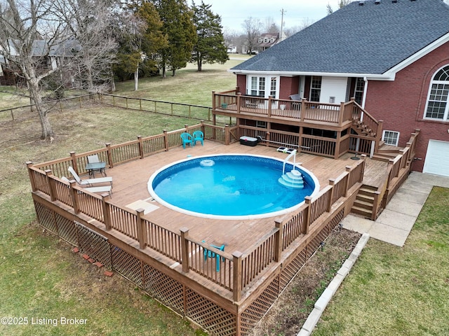 view of pool featuring a deck, a yard, a fenced backyard, and a fenced in pool