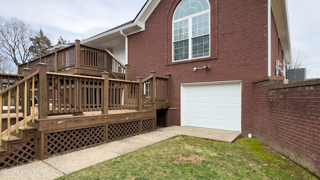 back of house with a garage, a wooden deck, and brick siding