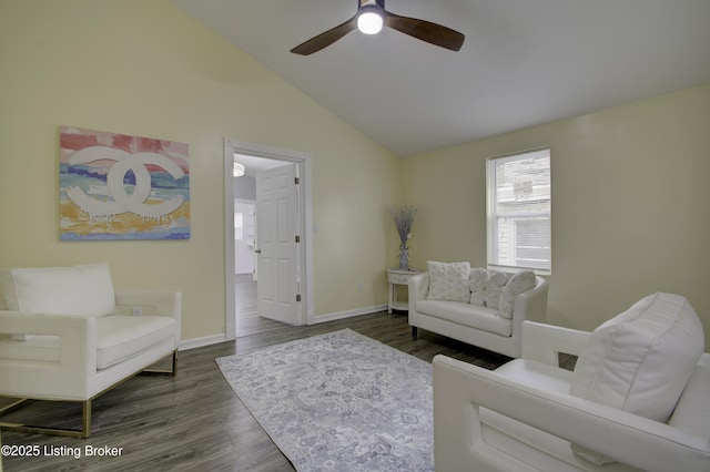 living room featuring ceiling fan, baseboards, vaulted ceiling, and dark wood-type flooring