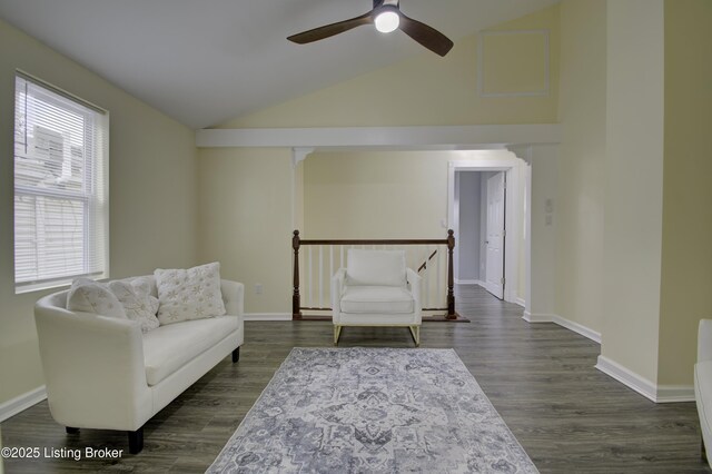 living area featuring dark wood-style floors, high vaulted ceiling, an upstairs landing, and baseboards