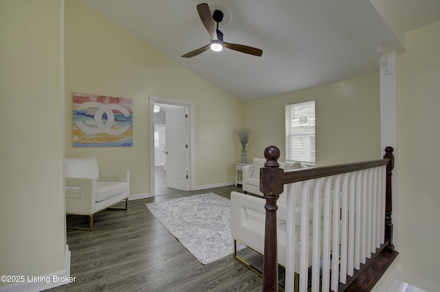 interior space with baseboards, vaulted ceiling, dark wood finished floors, and an upstairs landing