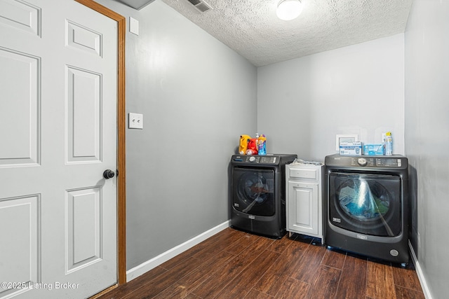 washroom featuring visible vents, baseboards, dark wood-style floors, independent washer and dryer, and a textured ceiling