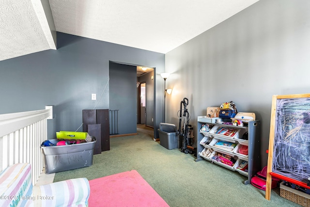 recreation room with lofted ceiling, a textured ceiling, and carpet flooring