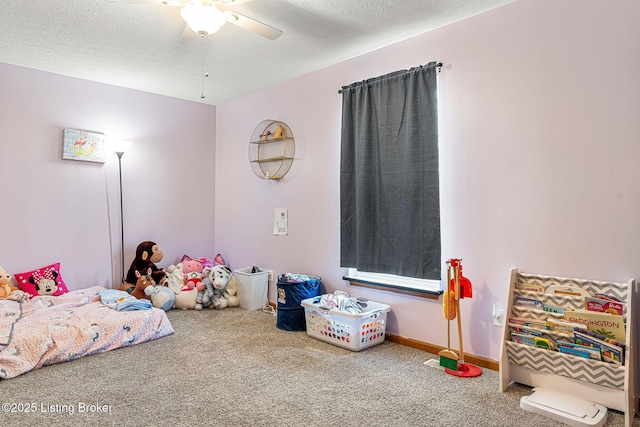 bedroom featuring a ceiling fan, carpet, a textured ceiling, and baseboards