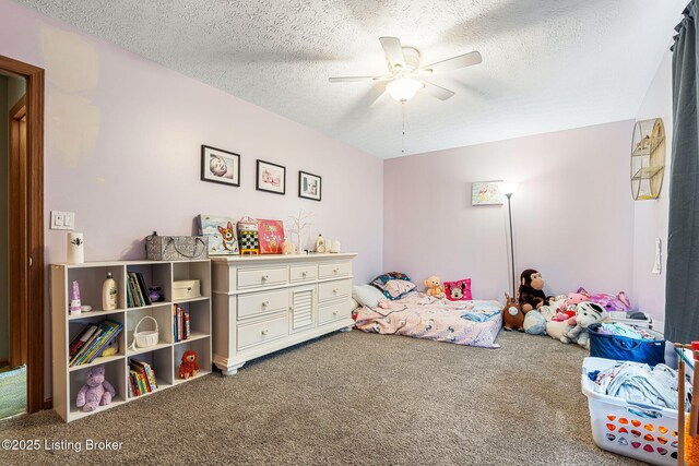 carpeted bedroom featuring ceiling fan and a textured ceiling