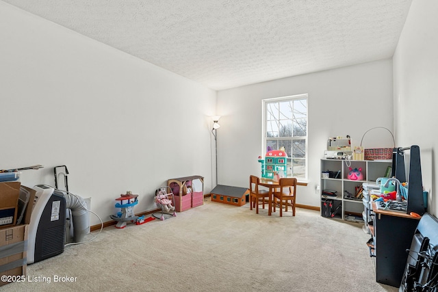 rec room featuring carpet floors, baseboards, and a textured ceiling