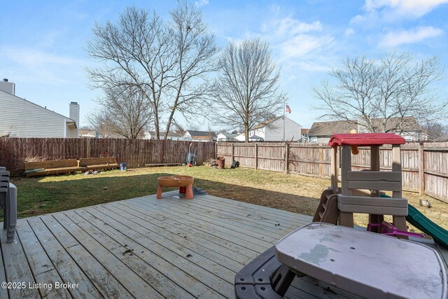 wooden terrace with a fenced backyard and a yard