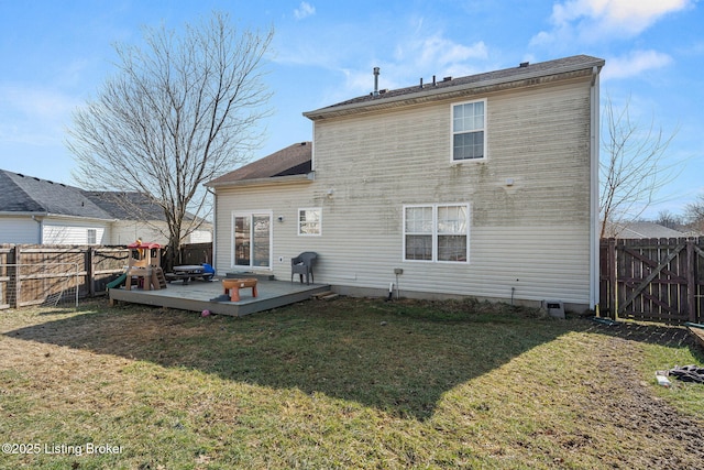 back of property featuring a fenced backyard, a yard, and a deck