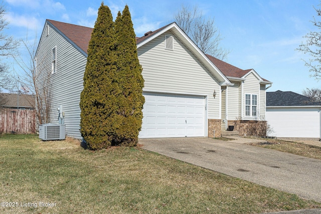 view of side of property featuring central AC unit, brick siding, fence, concrete driveway, and a lawn