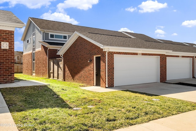 view of front of property featuring a front lawn, brick siding, a shingled roof, and an attached garage