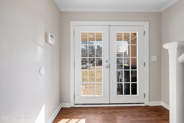 entryway featuring french doors, crown molding, and wood finished floors