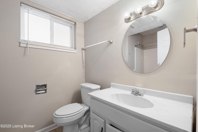 bathroom with toilet and vanity