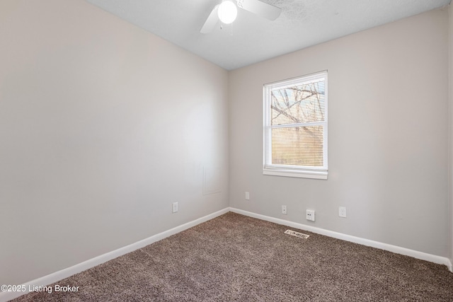 carpeted empty room with a ceiling fan, visible vents, and baseboards