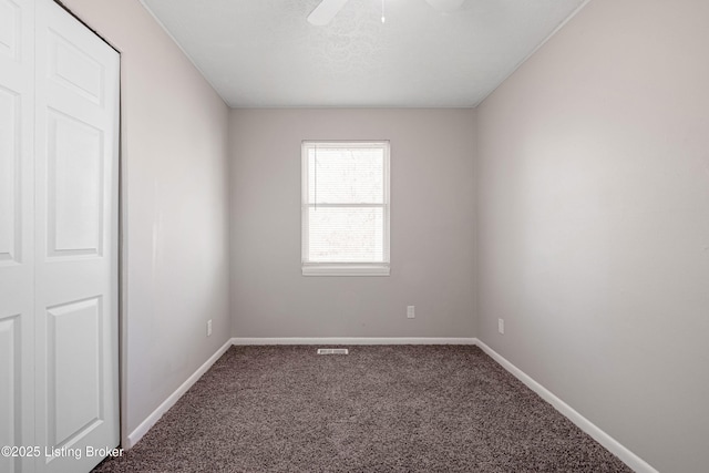 unfurnished room with ceiling fan, a textured ceiling, baseboards, and carpet flooring