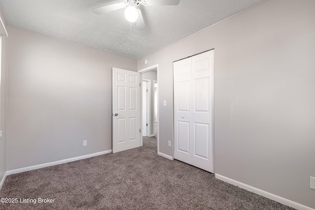 unfurnished bedroom featuring a ceiling fan, carpet, baseboards, and a closet